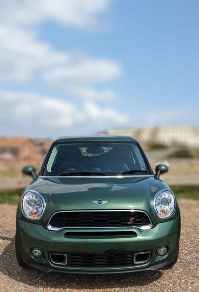Front view of a dark green Mini Cooper S