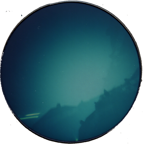 Hazy outlines of houses, in blue and grey.  A circular print.