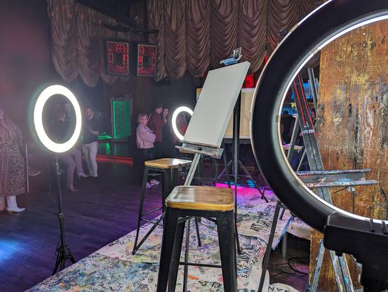 The aftermath -- easels and lights on the empty, paint-splattered stage at Art Battle