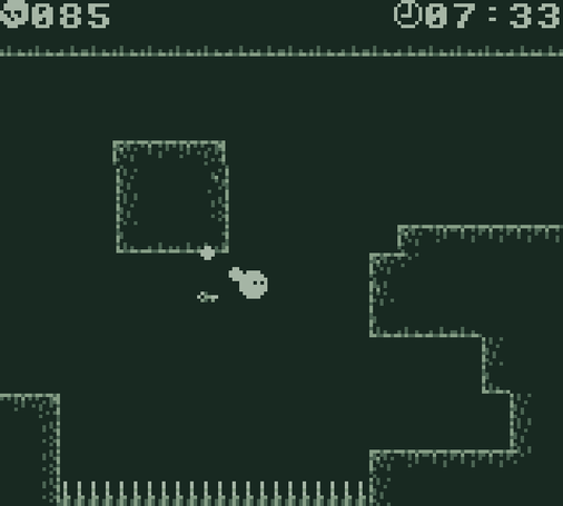 Screenshot from Slime Trials by Canight, the titular slime is hanging from a rectangular platform in the air above spikes on the bottom, with the exit key floating near it. The death counter is at 85, the timer is at 7 minutes and 33 seconds.