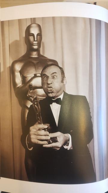 Mel Brooks pulling a funny face as he hold sup his Oscar