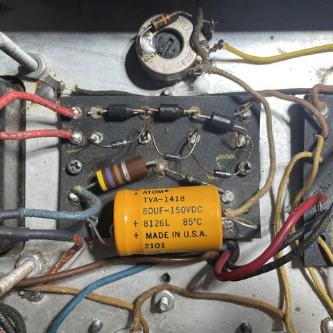 The rectifier and bias board of a 1968 Fender Twin Reverb guitar amplifier with a poorly-installed hodgepodge of old and newer components. Diode and capacitor leads are long and gangly, solder joints are poor, and lead dress is sloppy.