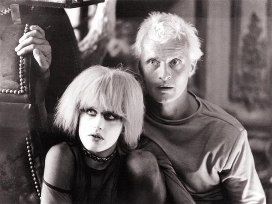 Darryl Hannah as Pris and Rutger Hauer as Roy Batty, the escaped Replicants, sitting together in a scene from Blade Runner