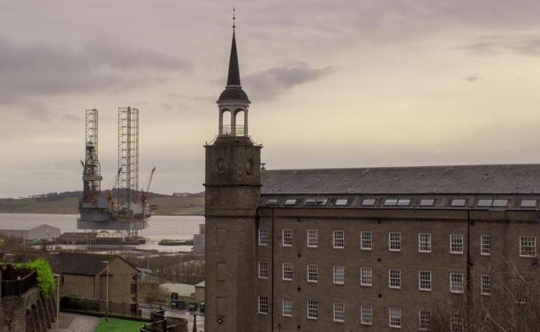 Old jute mill building and oil rig, mouth of the Tay, Dundee.