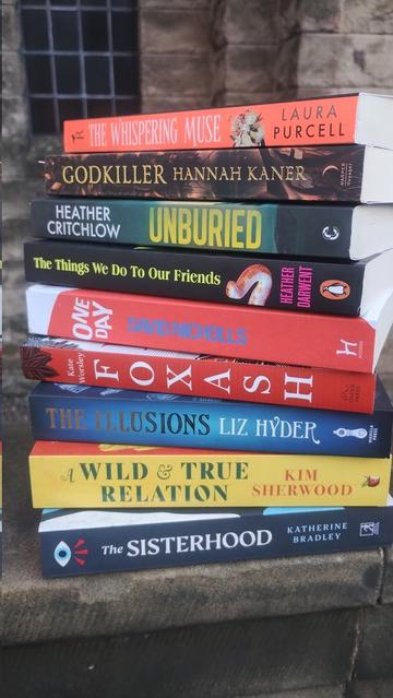 a pile of paperback new fiction, spin-on towards the viewer