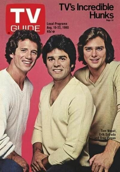 Three men pose and stare in to the camera
