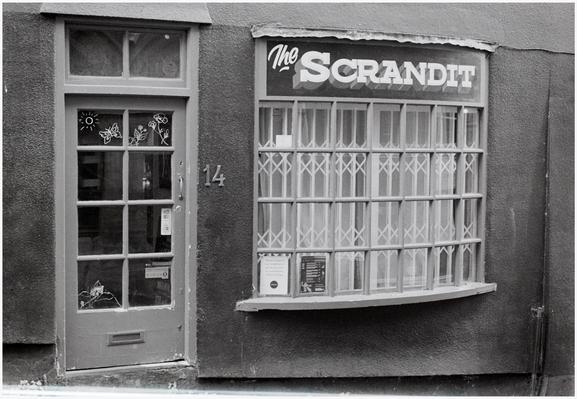 A black and white photograph of  Scrandit (as in 'settled up your food and drink tab or bill') a small food outlet at number 14 Christmas Steps, Bristol, UK.