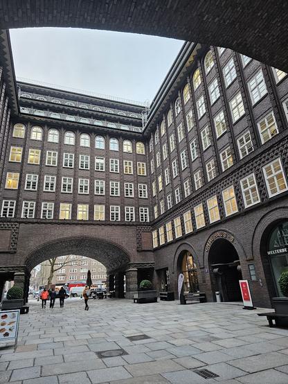 A large brick building with a large arched entrance.