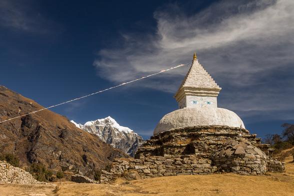 Photograph of a stupa, the religious monument, photographed above Namche Bazaar in the Khumbu Region of Nepal.