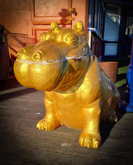 A bizarre mini statue of a hippo painted in gold