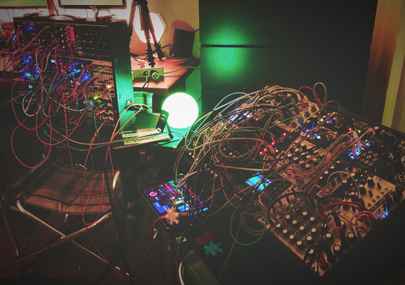Two fully patched 9u modular cases side by side. Lights blinking and vibes a vibin’.