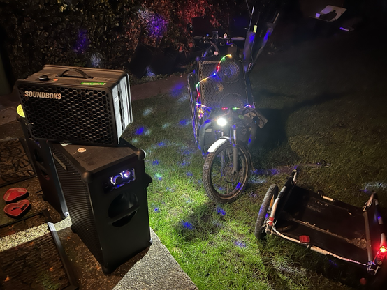 Speakers, trailer & cargo bike being unloaded.