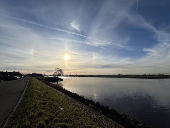 The sun with two sundogs above the river Hollandse IJssel, near Ouderkerk.