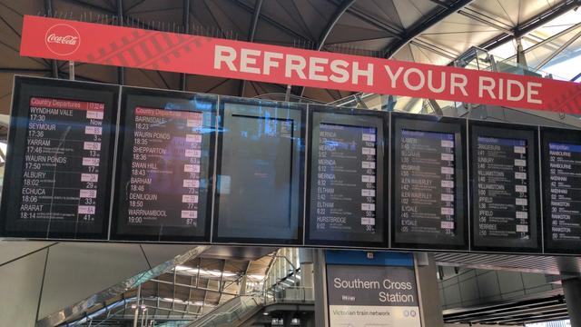 photo of screens showing next train departures at Southern Cross Station with another screen black and one screen showing "5:32" and all others "5:33"