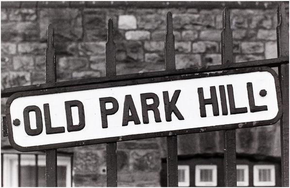 A black and white photograph of a name plate street sign attached, at a sloping up angle, to black painted iron railing at Old Park Hill, Bristol, UK. A building's stone facade forms the backdrop.
Ricoh KR10 with Rikenon 50mm F1.7 on Ilford Pan 400 developed in FX55 1+9 for 12.5 minutes at 21°C