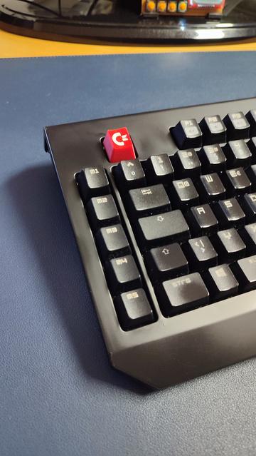 A Razer Blackwidow keyboard with a red ESC key which has a white Commodore logo.