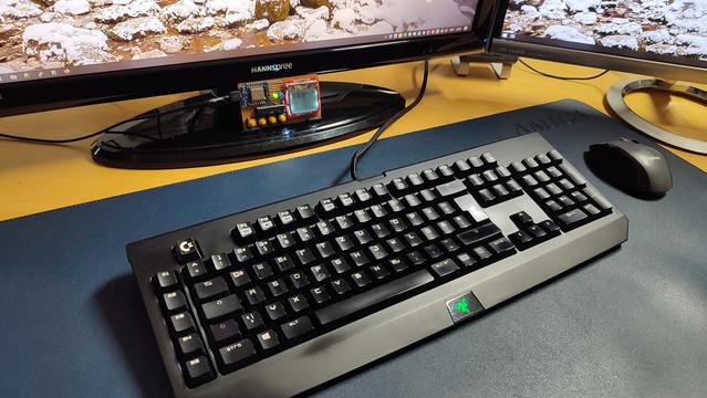 A Razer Blackwidow keyboard with a black ESC key which has a white Commodore logo.
