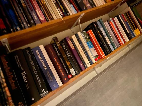 Photo of a shelf with books.