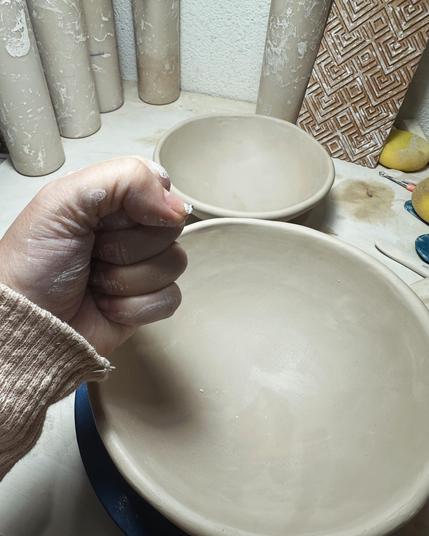 A photo of my hand in the shape of a fist in front of two bowls