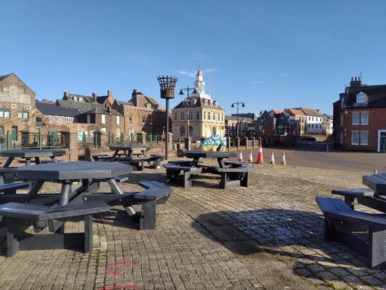 More picnic benches, with a millennium beacon, a decorated mammoth, some traffic cones and the famous Customs House beyond. The medieval and Georgian town buildings form the backdrop.