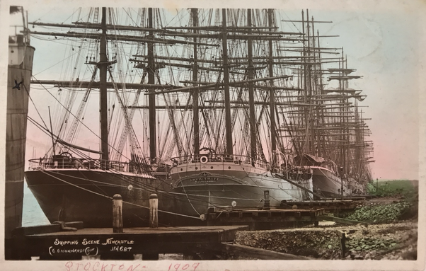 Sailing ships moored two across at a wharf in Stockton, NSW in 1909.