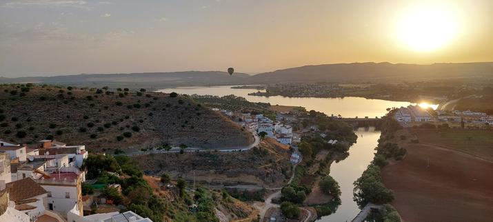 Photo at sunset from the village of Arcos de la Frontera overlooking the valley, hot air balloons, the river and the reservoir.