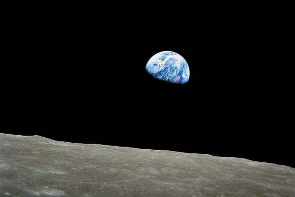 Earth rising above the moon.