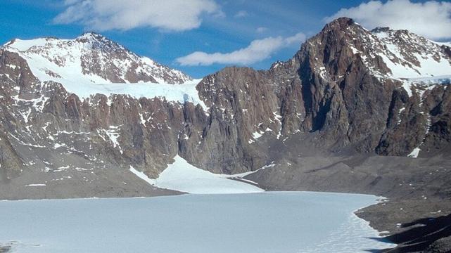 Ice covered Lake Untersee, Antarctica, surounded by mountains. (photo by André Pellerin)