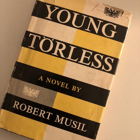 Cover in yellow, black, grey and white of the novel with Austrian double-headed eagle.