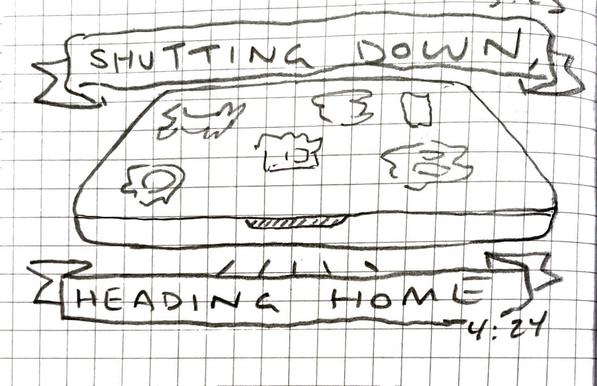 A closed laptop, its lid covered in stickers. Banners read, “SHUTTING DOWN, HEADING HOME”
