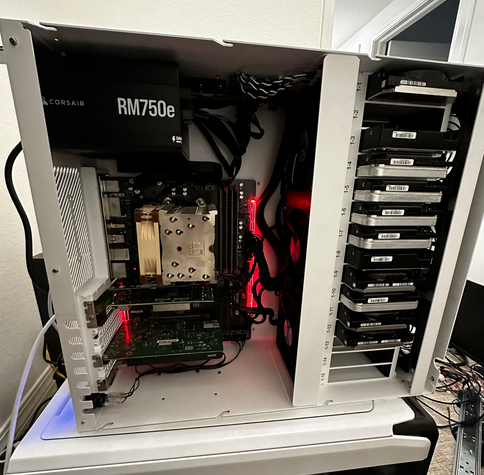 computer guts. lots of drives on the right side. motherboard and PSU on left.