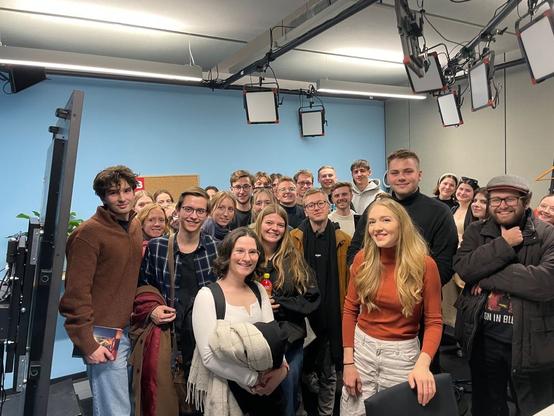 Studierendengruppe in einem TV Studio mit der Moderatorin Ambra Schuster