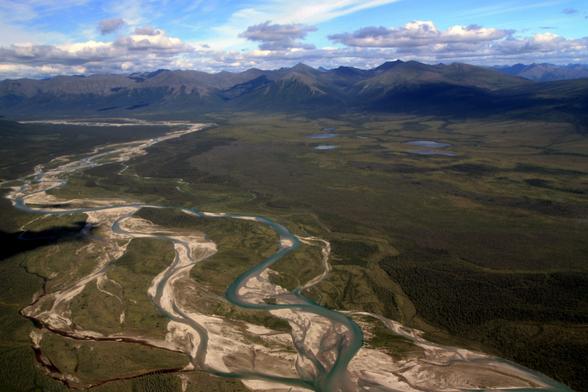 oblique aerial photo - watershed, braided river and mountains in the background, Alaska