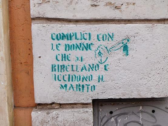 "COMPLICI CON  LE DONNE  CHE SI RIBELLANO  E UCCIDONO IL  MARITO"  stencil text  in blue/green