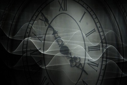 Art by Eddi van W. on Flickr: black and white close-up image of an old-fashioned clock face with roman numerals and ornate hands with translucent drifting wave forms wafting in front of it