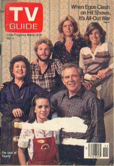The cast pose in characters around a staircase.
