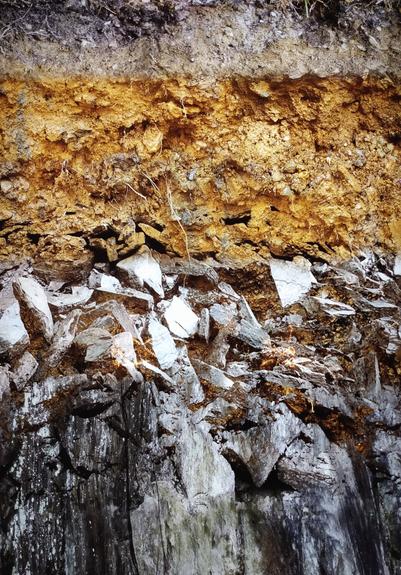 A colour picture of different layers of earth. The deeper you go, the more stone material there is.
