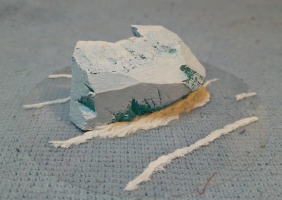 an iceberg for wargaming, carved and painted foam on top of clear plastic with painted waves