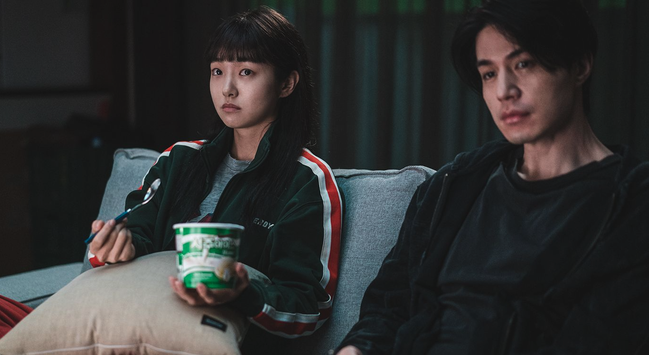 Kim Hye Joon & Lee Dong Wook sitting on a couch in a still from South Korea's 2024 drama "A Shop for Killers."
