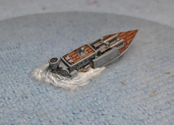 miniature wargame ship sinking, frothy waves as it tips up