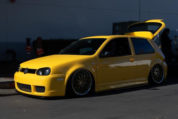 Yellow hatchback on lowered suspension