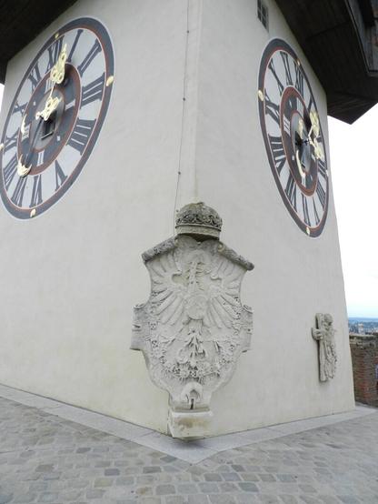 The clock tower in Graz. One side, showing two of the clocks.