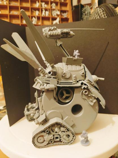 Anoth shot showing the grey primed scale tank, or "Tonk" model / tabletop miniature.

Made primarily from an old sellotape dispenser, split apart and widened with a single large central track added to give it a bit of a Kugelpanzer vibe. I eventually  added the side tracks and Appleseed style aerials as an after thought.