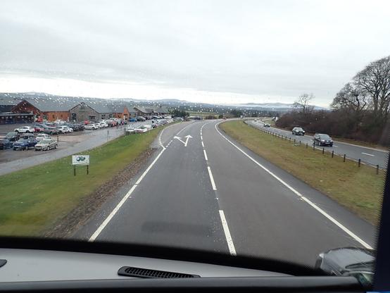 I will never get bored of sitting on the front seat of the top deck of a bus. Photo is looking out the rainy window to the big road we are heading down.