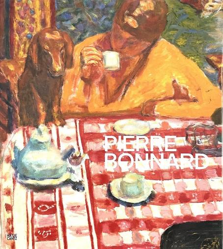 A book with numerous authors, entitled  Pierre Bonnard. The colorful cover painting is of a woman dressed in bright yellow is sipping from a small cup. Her other arm is resting on table with a a bright red & white checked tablecloth. A little dachshund has its front paws on the table beside her. The painting is by French painter Pierre Bonnard.