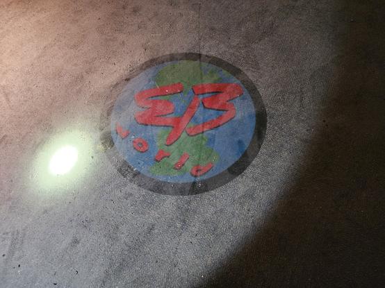 A carpet. In the center is a black circle with the words EB world. The background is of north and south america