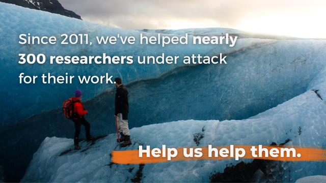 Photo of two scientists on an icy landscape. Text overlay reads "Since 2011, we've helped nearly 300 researchers under attack for their work. Help us help them."