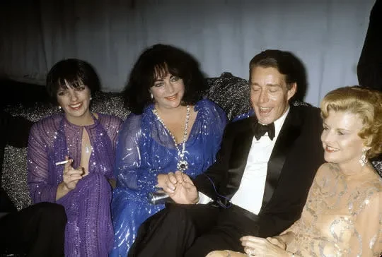 color candid photo of the four seated together, smiling as Halston talks