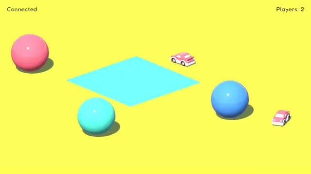Screenshot of Unity x socket.io game experiment. Two red cars driving around a yellow surface with 3 coloured spheres