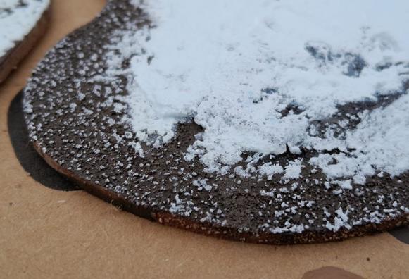 close up of miniature wargaming terrain.  a snow covered rocky island